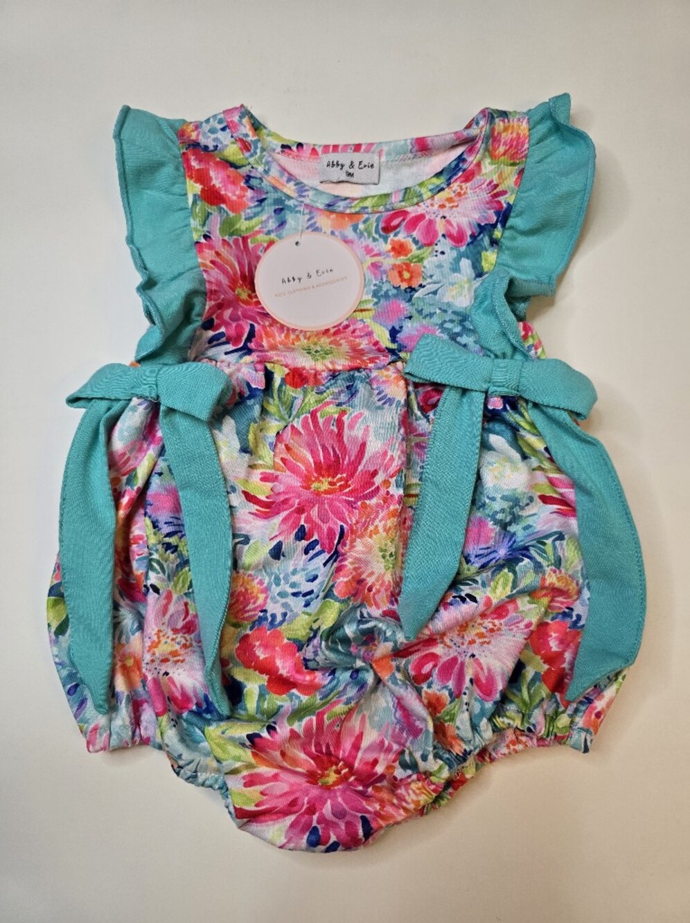 Abby + Evie Floral Baby Romper with Teal Accents